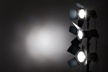 Several reflectors on the black background in photo studio.