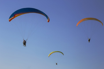Three paragliders in the sky