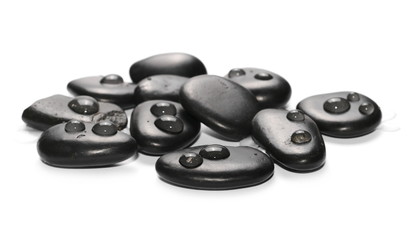 Black spa stones with water drops isolated on white background