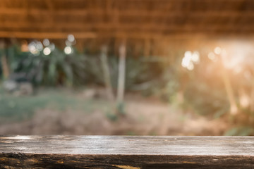 Product display montage of Empty wooden table and blurred forest walkway view or natural background
