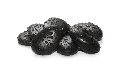 Black spa stones with water drops isolated on white background