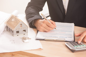 Mortgage Application Form - Hand Filling The Document Closeup