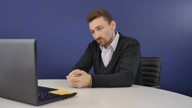 Angry boss has a business conversation on webcam in the office