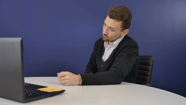 Angry boss threatens the partners with a wooden ax during video conference