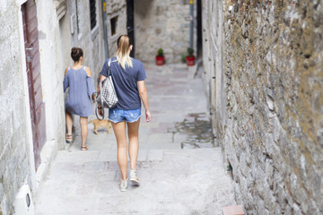 tourists walk along a deserted street