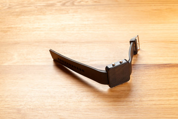 Smart watches lying on wooden background
