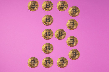 Golden bitcoin coins in form of BITCOIN LOGO or in form of B letter. Bitcoins, golden bitcoins, yellow bitcoins. Cryptocurrency physical golden coins.