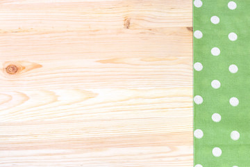 Tablecloth with polka dots on a wooden table. Horizontal.