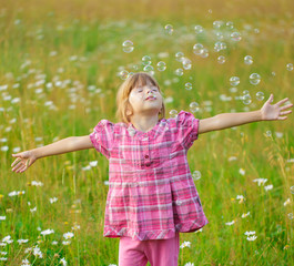 Small girl on camomile field