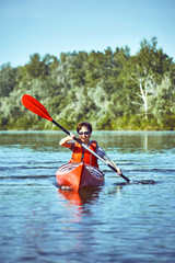 Fototapeta premium A canoe trip along the river along the forest in summer.