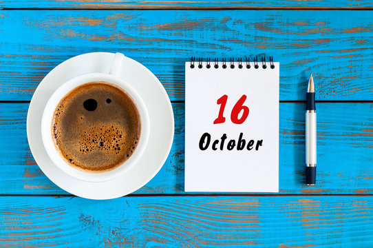 October 16th. Day 16 of october month, calendar on workbook with coffee cup at student workplace background. Autumn time