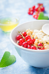 Oatmeal healthy breakfast with berries and honey. Selective focus, Space for text.