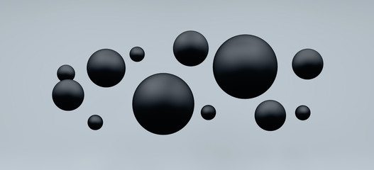 Plastic black balls flying on grey background.