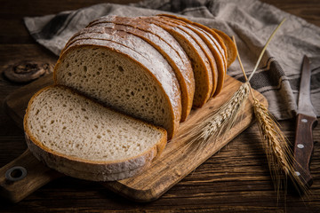Sliced loaf of bread on a chopping board.