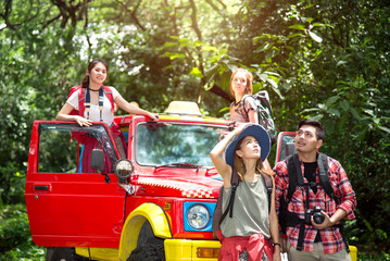 Group Trip of Young Asian Backpacker Travel with 4WD Off Road Adventure in the Forest in Thailand - Holiday Concept