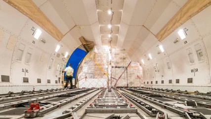 Loading air cargo freighter inside aircraft - Zoom out