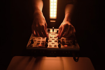 DJ mixer disco illuminated by searchlights