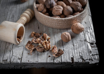 Nuts on bold in foreground on aged wooden table.
