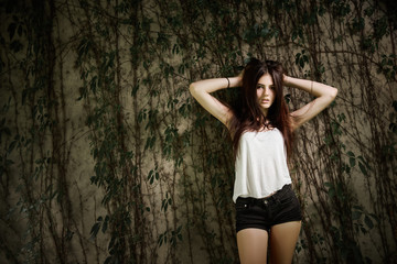 Concept: gritty, millennial. Gorgeous beautiful young woman photoshoot in abandoned location presenting the contrast of fashion and grunge.