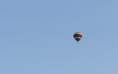 A balloon is flying in the blue sky