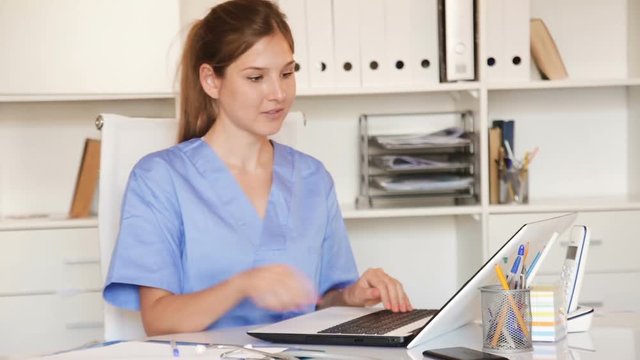 Female doctor working with medical records in office
