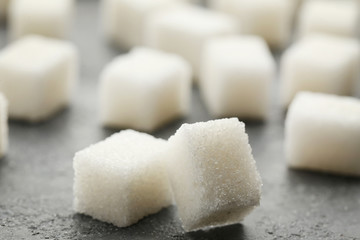 Sugar cubes on grey wooden table