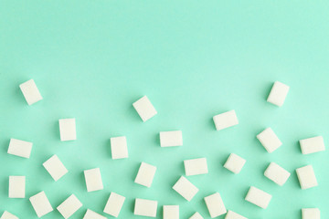 Sugar cubes on mint background