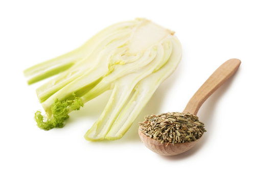 Ripe fennel bulb and dry seeds in spoon isolated on white background