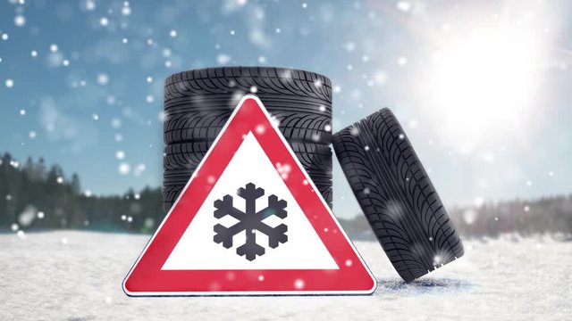Winterreifen auf Schnee mit Gefahrenzeichen