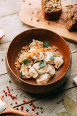 dumplings with potatoes, cheese, berries, compositions for the menu of the restaurant, decorated with greens and sauce