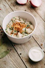 dumplings with potatoes, cheese, berries, compositions for the menu of the restaurant, decorated with greens and sauce