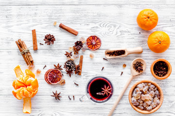 Hot mulled wine or grog cooking for new year celebration with oranges and spices ingredients on...