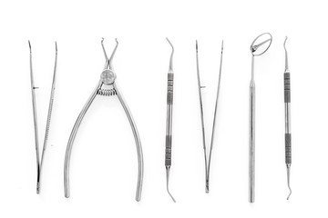 Set of dentists tools including round mirror on white background top view