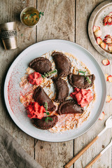 dumplings with potatoes, cheese, berries, compositions for the menu of the restaurant, decorated with greens and sauce