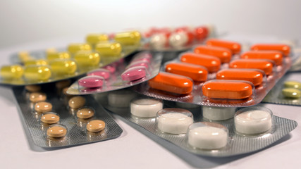 a set of various tablets and capsules in blisters