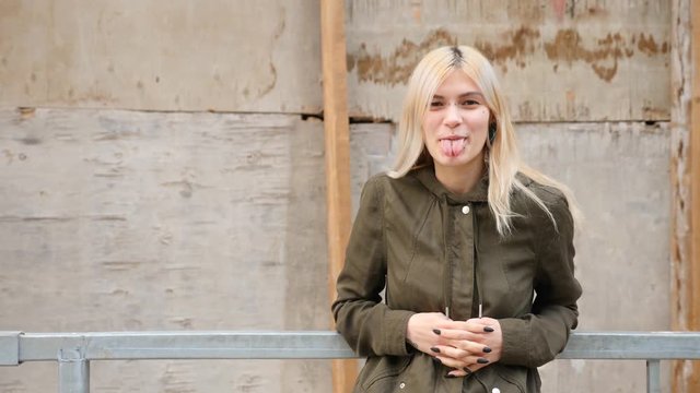 bodimodification, portrait of a girl with face piercings and tunnels in the ears. 4k, slow-motion shooting, copy space