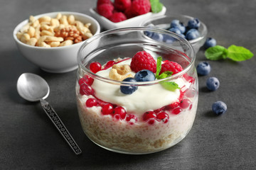 Tasty quinoa with berries in jar on table