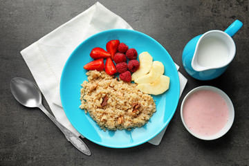 Plate with tasty quinoa on table