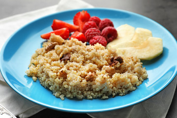 Plate with tasty quinoa on table