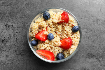 Tasty quinoa with berries in jar on table