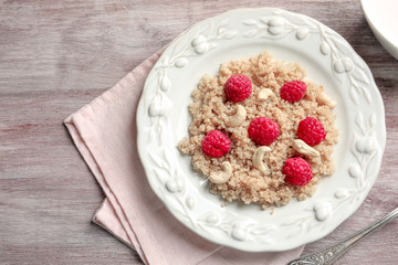 PLate with tasty quinoa on table