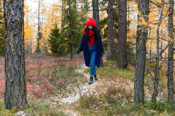 Pretty young woman walking in the forest