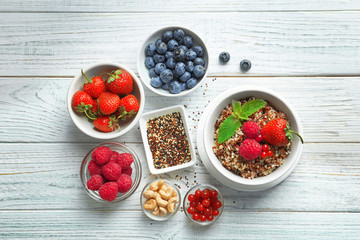 Beautiful composition with tasty quinoa on wooden table