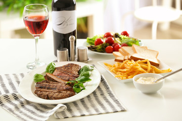 Plate with delicious grilled steak in restaurant