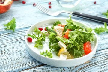 Plate with fresh salmon salad on table