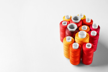 Red and orange threads of different shades on white background