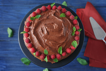 Dessert stand with delicious chocolate cake on wooden background
