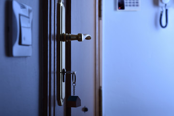 Door with keys in the lock security night concept