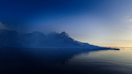 Arctic Icebergs Greenland in the arctic sea. You can easily see that iceberg is over the water surface, and below the water surface. 