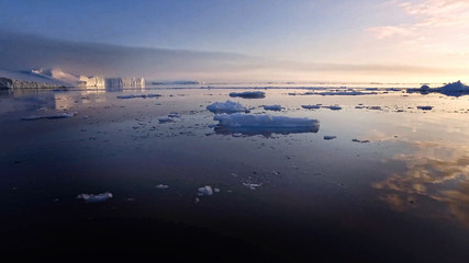 Fototapeta premium Arctic Icebergs Greenland in the arctic sea. You can easily see that iceberg is over the water surface, and below the water surface. 